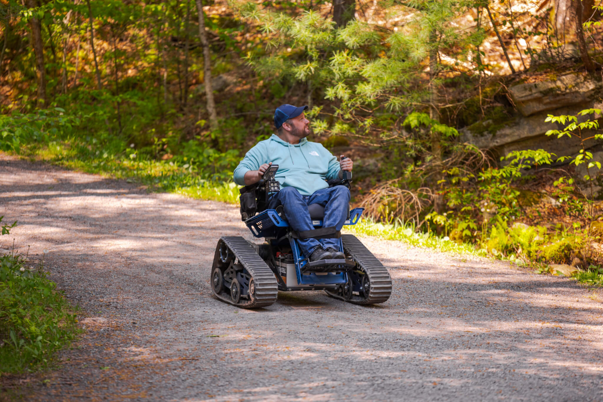 Trackchair AXIS tracked mobility chair on a wooded outdoor trail